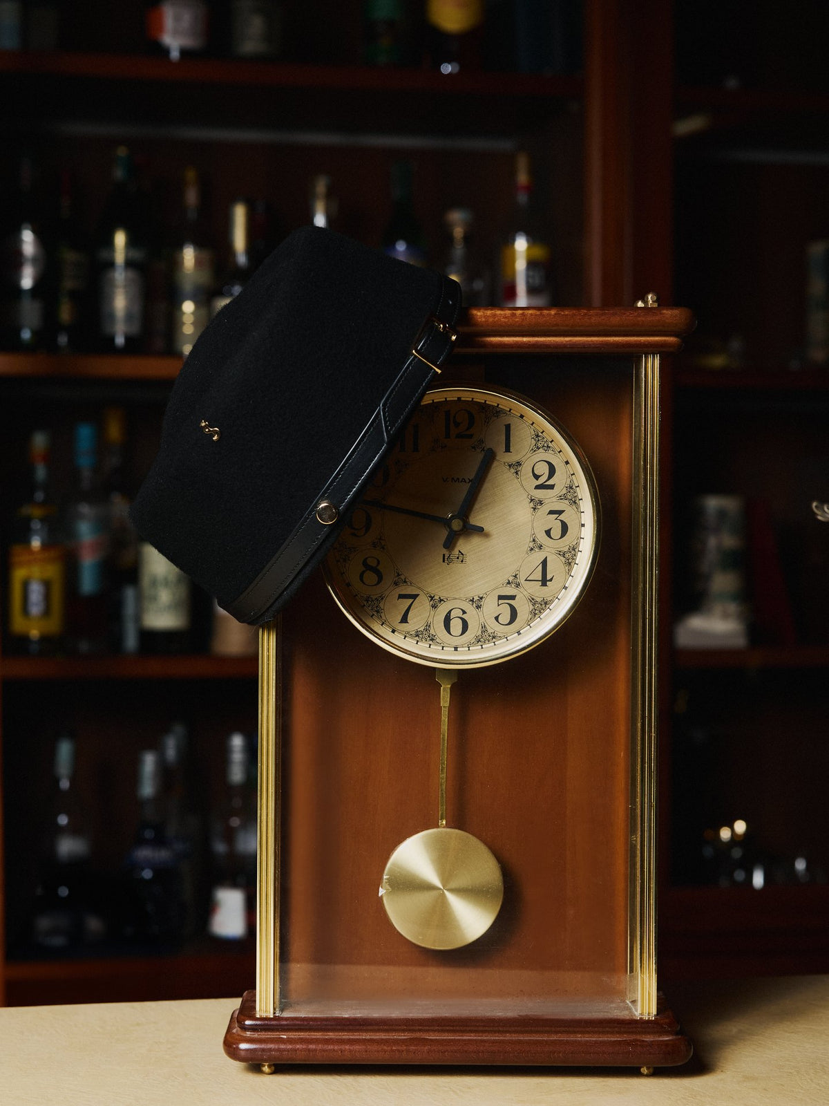 The Diana pillbox hat beside a clock